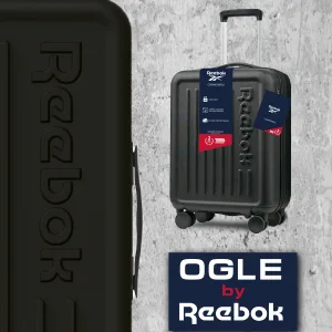 FCSI | Black Reebok suitcase with four wheels on a concrete background. It features an embossed Reebok logo and a tag highlighting its characteristics. Additional branding text "OGLE by Reebok" is displayed below.