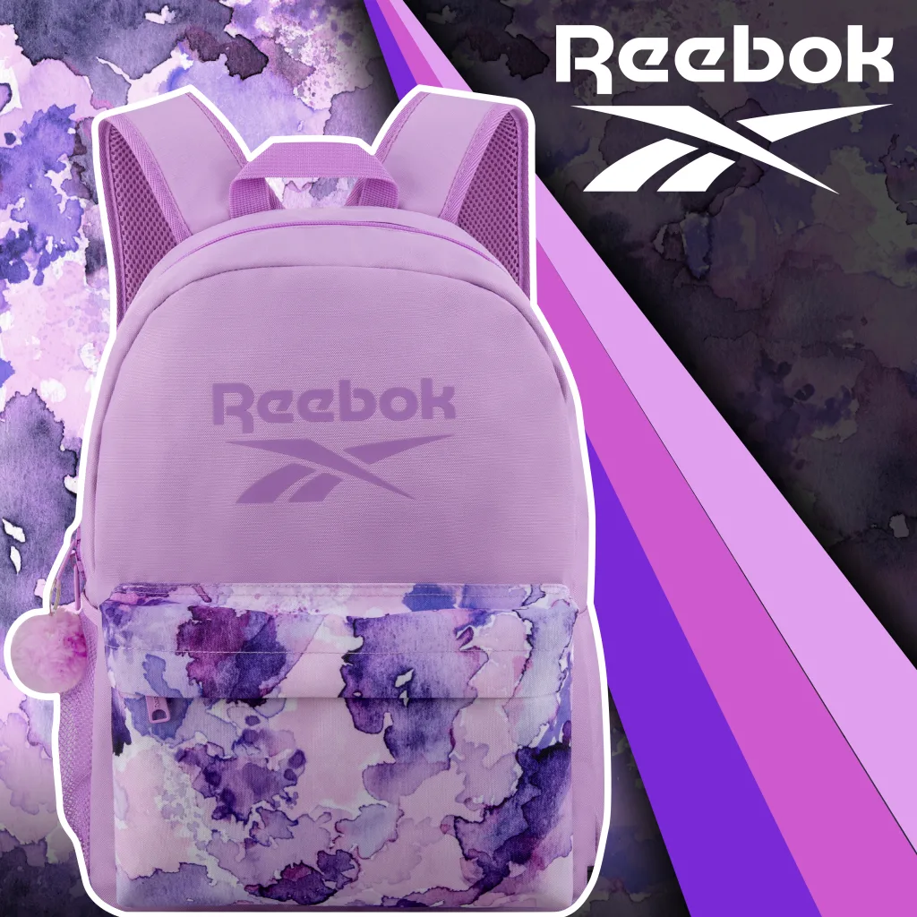 FCSI | A lavender Reebok backpack with a watercolor design on the front pocket. The background features abstract purple patterns, and the Reebok logo is displayed prominently at the top.