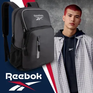 FCSI | A person with short red hair wears a black Reebok hoodie and plaid shirt. Beside them is a black Reebok backpack. The background features a Reebok logo and a red, white, and blue stripe design.