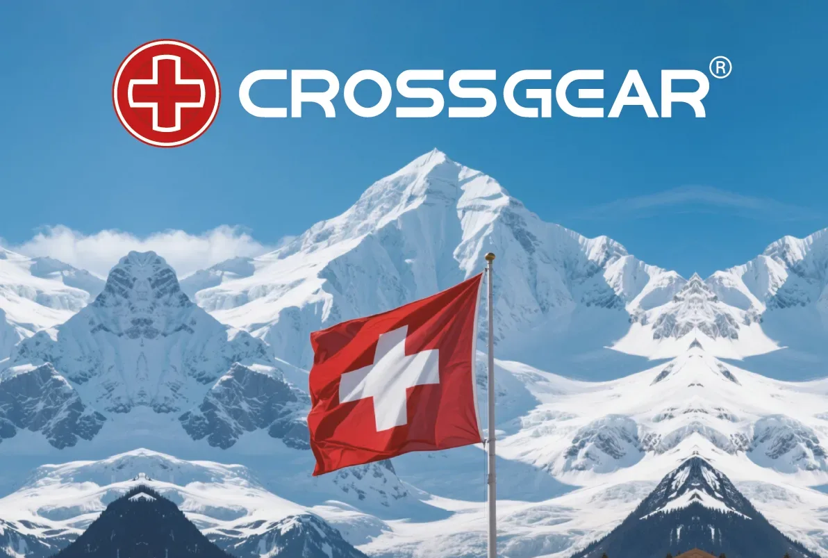 FCSI | A Swiss flag waves in front of snowy mountain peaks under a blue sky, with the Crossgear logo featuring a red cross symbol and text at the top of the image.